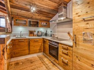a kitchen with wooden cabinets and a stove at Appartement de Charme à Courchevel 1850 - 4 pers, Centre, Proche des Pistes, Balcon et Hammam - FR-1-631-163 in Courchevel +3 photos