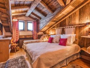 a bedroom with a large bed in a room with wooden walls at Appartement de Charme à Courchevel 1850 - 4 pers, Centre, Proche des Pistes, Balcon et Hammam - FR-1-631-163 in Courchevel