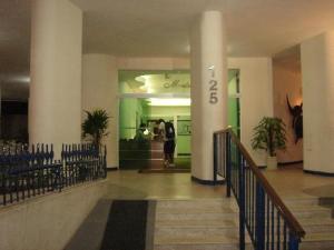 a lobby with stairs in a building with a number on it at apartamento Edificio Master in Rio de Janeiro