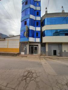 un edificio azul al lado de una calle en Hostal Garcilaso - Garaje Amplio, en Abancay