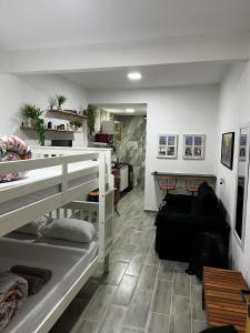 a room with two bunk beds and a living room at Meu Loft Barra Nova 3 in Saquarema