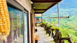 a building with a window with a view of a mountain at Hà Lù Homestay in Lao Cai