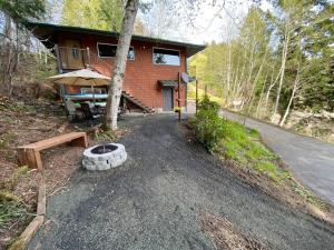 a house with a road leading up to it at Hammersley Inlet- Oyster beach apt, Relaxing Views in Shelton