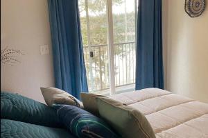 a living room with a couch and a window at Hammersley Inlet- Oyster beach apt, Relaxing Views in Shelton