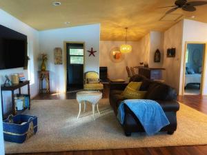 a living room with a couch and a table at Hammersley Inlet- Oyster beach apt, Relaxing Views in Shelton