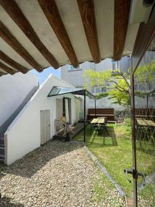 an outdoor patio with a table and an umbrella at Inner-Stay in Tongyeong