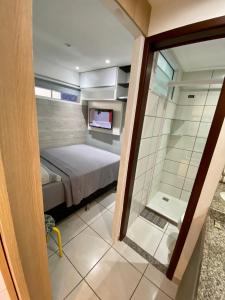 una piccola camera con letto e doccia di APARTAMENTO 17º Andar Beira Mar com 2 QUARTOS a Fortaleza