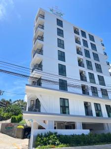 a white building with balconies on it at iCheck inn Darisa Patong in Patong Beach