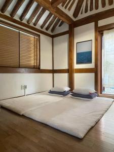 a bedroom with two pillows on a large bed at Inner-Stay in Tongyeong