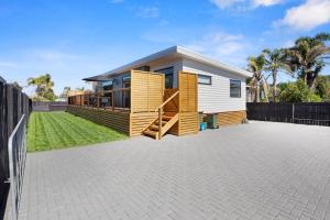 a tiny house with a large backyard at Leisure on Leo in Waihi Beach