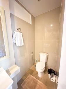 a white bathroom with a toilet and a shower at Favorite Place in Kata Beach