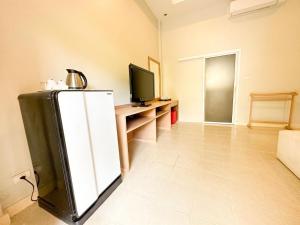 a living room with a refrigerator and a television at Favorite Place in Kata Beach