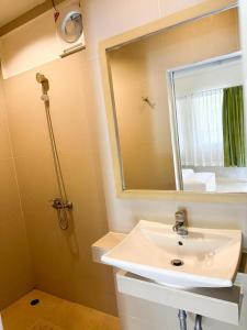 a bathroom with a white sink and a mirror at Favorite Place in Kata Beach