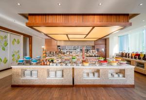 a kitchen with a lot of food on a counter at A La Carte Da Nang Beach in Danang