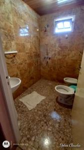 a bathroom with two toilets and a sink and a shower at ALDAO in Malargüe