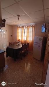 a dining room with a table and a refrigerator at ALDAO in Malargüe