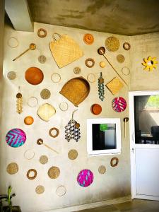 a wall with a bunch of different objects on it at Tamara Motels in Hikkaduwa