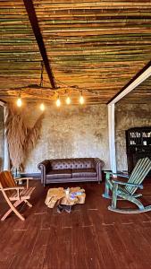 a living room with a couch and two chairs at ALMAH GLAMPING in Cali