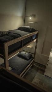 two bunk beds in a room with a light at Ranasa Yogyakarta in Timuran