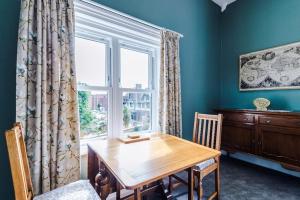 a dining room with a wooden table and a window at 1B Victorian Retreat in Chester in Chester