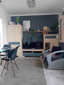 a living room with a tv and a table and chairs at Mieszkanie na doby w Kutnie centrum ulPodrzeczna in Kutno