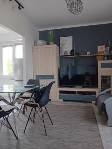 a living room with a glass table and chairs at Mieszkanie na doby w Kutnie centrum ulPodrzeczna in Kutno +17 photos