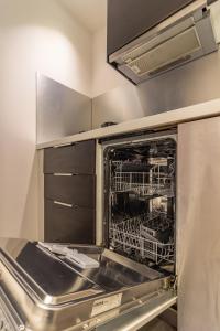 a dishwasher with its door open in a kitchen at 403 · Wonder Appart' - Vue sur Garonne - in Toulouse