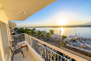 a balcony with a view of the water and a boat at Rhapsody of Luxor in Luxor