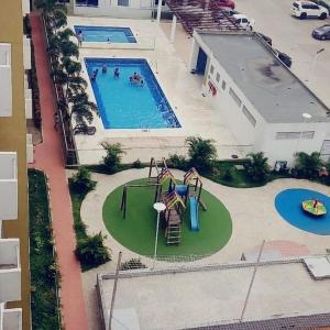 Apartamento Amoblado Cartagena في كارتاهينا دي اندياس: اطلالة علوية على مسبح مع ملعب