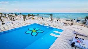 a pool with a flower painted on it next to the ocean at Sunrise Arcadia Sky in Odesa