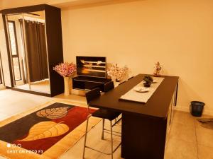 a living room with a table and a fireplace at Cozy unit- Bell suites- Horizon Suites- Wifi- Netflix- Parking Swimming Pool- Klia in Sepang