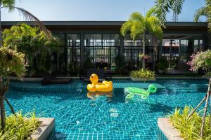 a swimming pool with toys in a resort at Guuden Huahin Hotel in Hua Hin