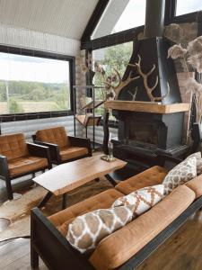 a living room with a couch and a fireplace at HYTTE - Cozy Stay For Families & Friends 