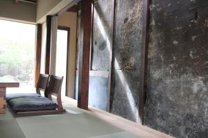 a room with two chairs sitting next to a wall at Zen Machiya Private Residence near Heian Shrine in Kyoto +28 photos