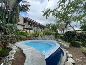 a swimming pool in a yard next to a building at The Lakeview Suites in Tagaytay