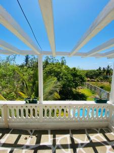 a white porch with a view of the ocean at Silent Palms Villa in Galu