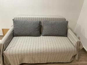um sofá com duas almofadas em cima em C1 Madrid, Zona exclusiva em Madrid