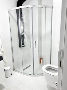 a shower stall in a bathroom with a toilet at Luxury Apartment with Garden right by sea in Mudanya