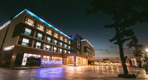 a building with a sign in front of it at night at Hotel Sweet Castle Jeju Hamdeok in Jeju