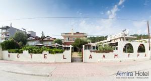 a sign for a hotel in a city at Hotel Almira in Agia Triada