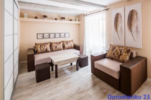 a living room with a couch and a table at Do Lvova Central Apartments in Lviv