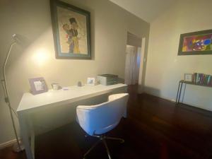 a room with a white desk and a chair at Hallorans Hill Holiday Home in Atherton