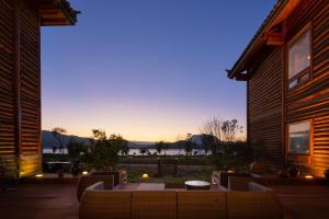 a patio with a table and chairs in front of a house at Slow Living Villa in Ninglang