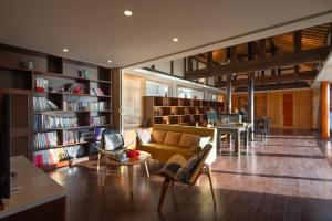 a living room with a couch and bookshelves at Slow Living Villa in Ninglang