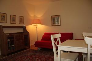 a living room with a red couch and a red chair at Premarental Apartment in Vienna