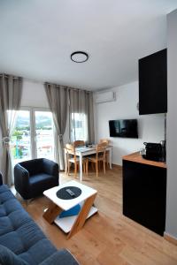 a living room with a couch and a table at Blue Lagoon 3 in Kavala