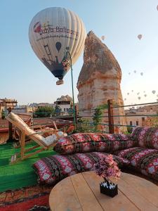 a hot air balloon and pillows on top of a roof at Vintage Cave House Hotel in Goreme
