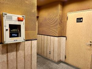 a row of lockers in a bathroom with a door at Cypressinn Tokyo in Tokyo