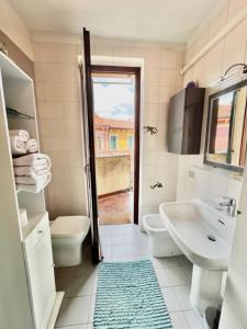 a white bathroom with a sink and a toilet at Casanova Loc Turistica in Verona