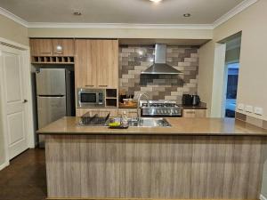 a kitchen with a sink and a microwave at Tranquil home in Point Cook. in Point Cook